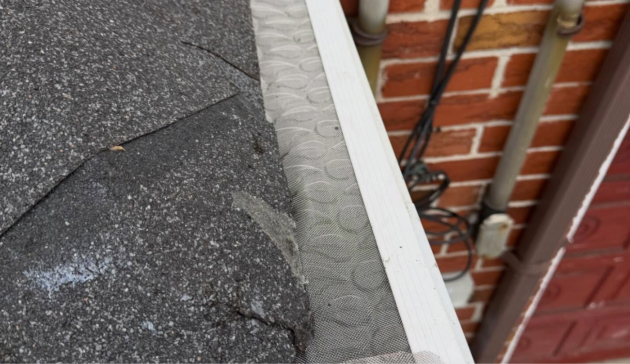 A completed residential project showing seamless white gutters and downspouts after a successful house gutter installation service.
