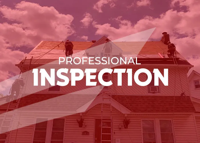 Workers perform a professional roofing inspection on a two-story residential house. Several crew members use ladders and safety ropes while navigating the sloped roof under a cloudy sky in Long Island.