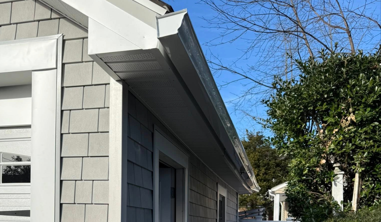 Clean white trim and eaves on a modern home exterior after completing a professional-grade soffit repair.
