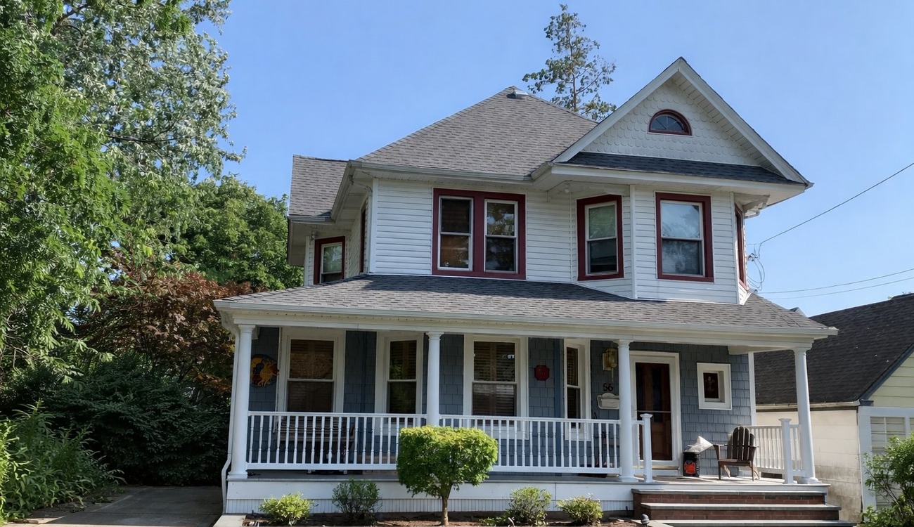 A beautiful, historic two-story home showcasing a freshly completed roof replacement in New York.