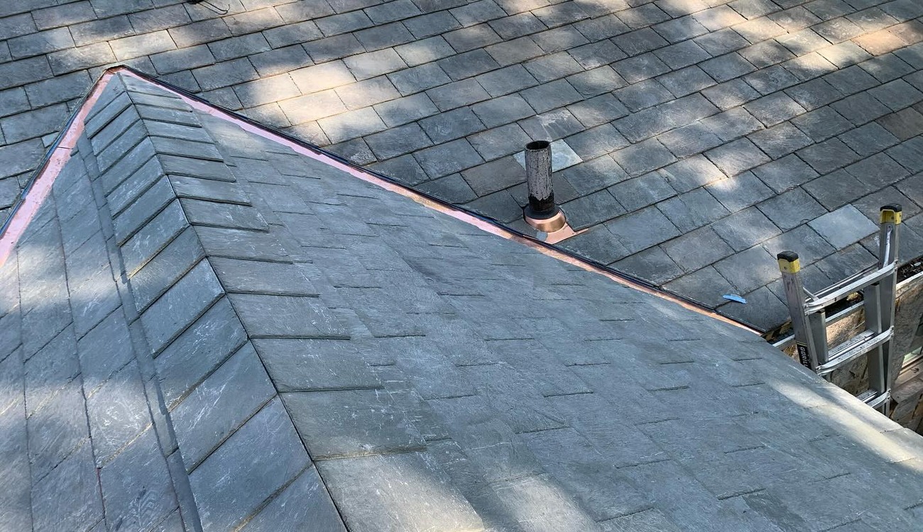 Close-up of expert slate and copper flashing installation by a roofing contractor in Nassau County.